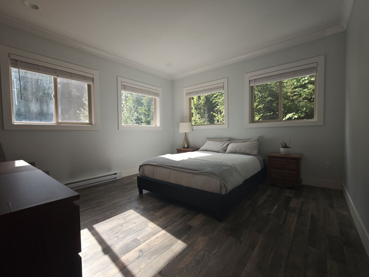 Bedroom with forest windows